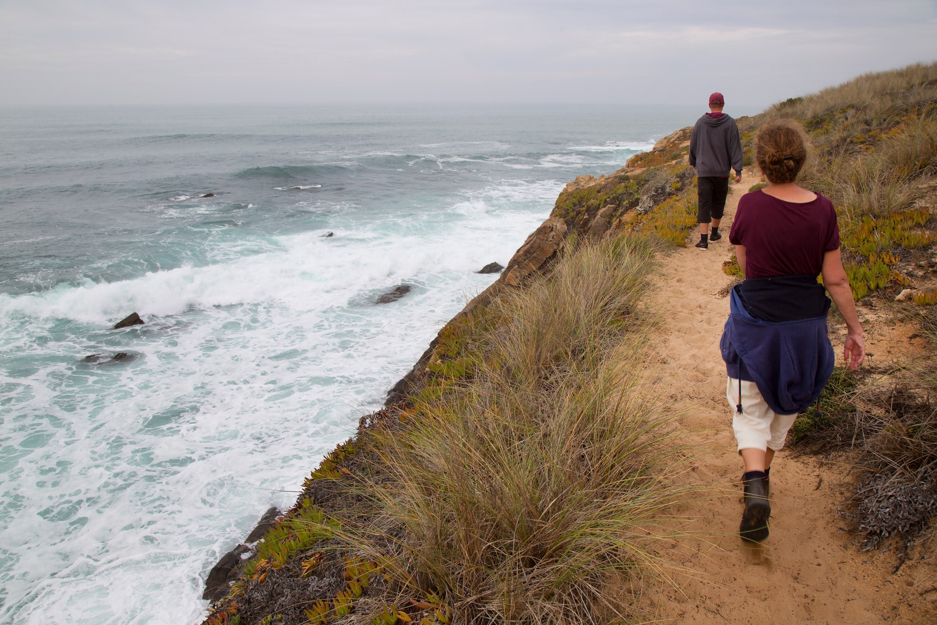 Couple walking by the coast